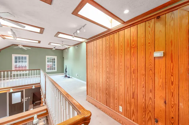 a bathroom with a granite countertop sink and a large mirror