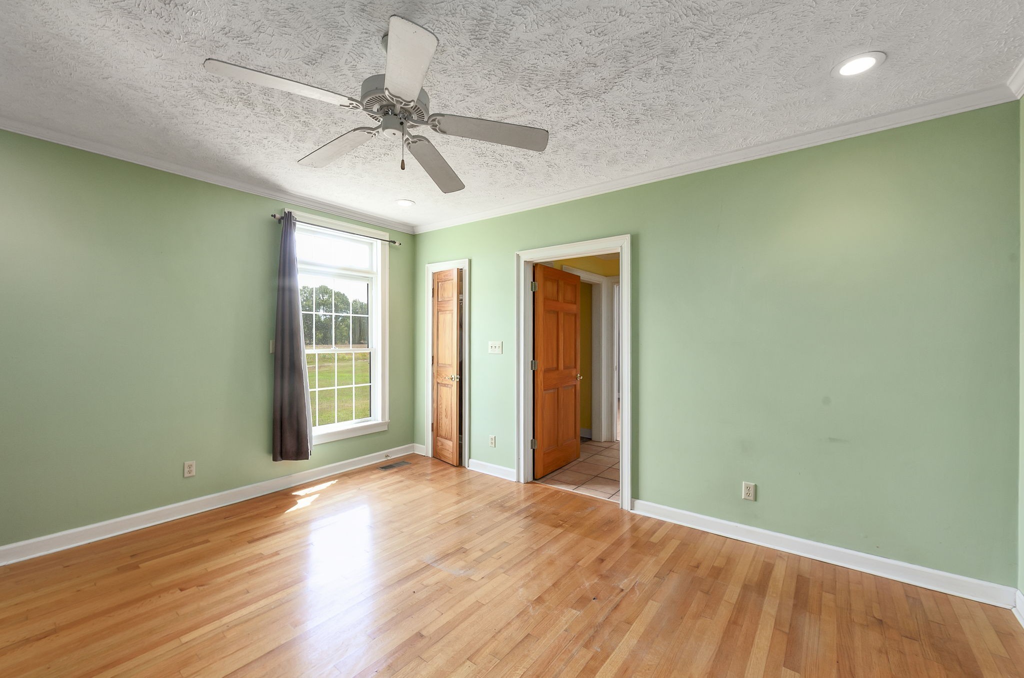 290 Leeford Lane Cedar Grove, TN 38321 - Photo 35 of 54 an empty room with wooden floor fan and windows
