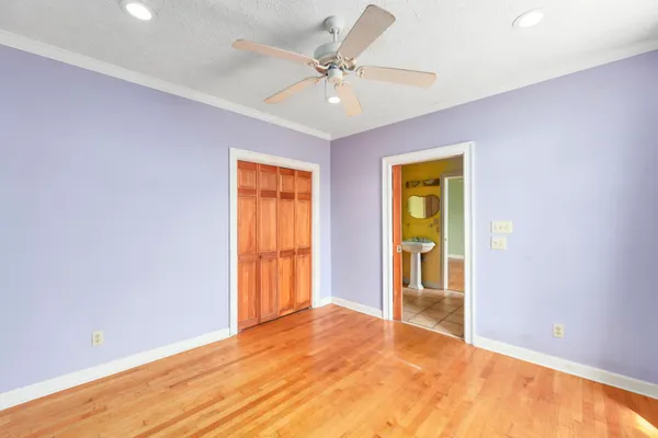 a view of an empty room with a fireplace and a window