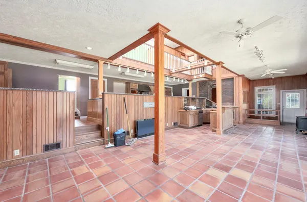 a view of a room with wooden ceiling