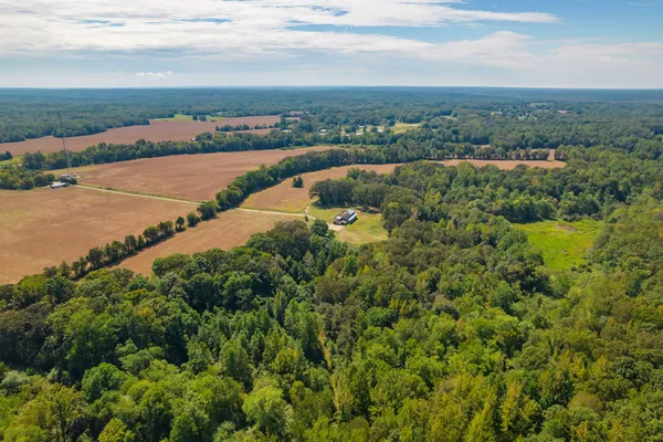 an aerial view of a house with a yard and lake view
