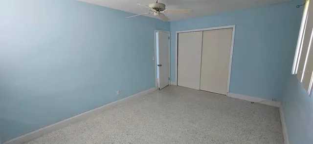 a view of empty room with a kitchen
