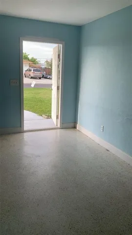 a view of empty room with floor to ceiling window