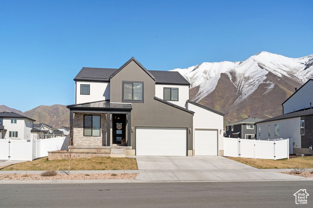 3169 Pinyon Pk Lane Mapleton, UT 84664 - Photo 1 of 1 Modern farmhouse featuring a standing seam roof, fence, and a mountain view