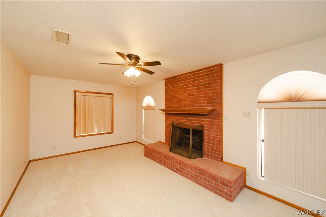 Red brick fireplace with hearth and wood mantel