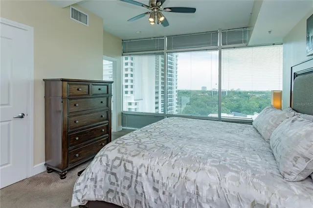 a bedroom with a bed and a television