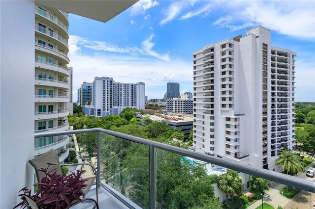 a balcony view with tall trees