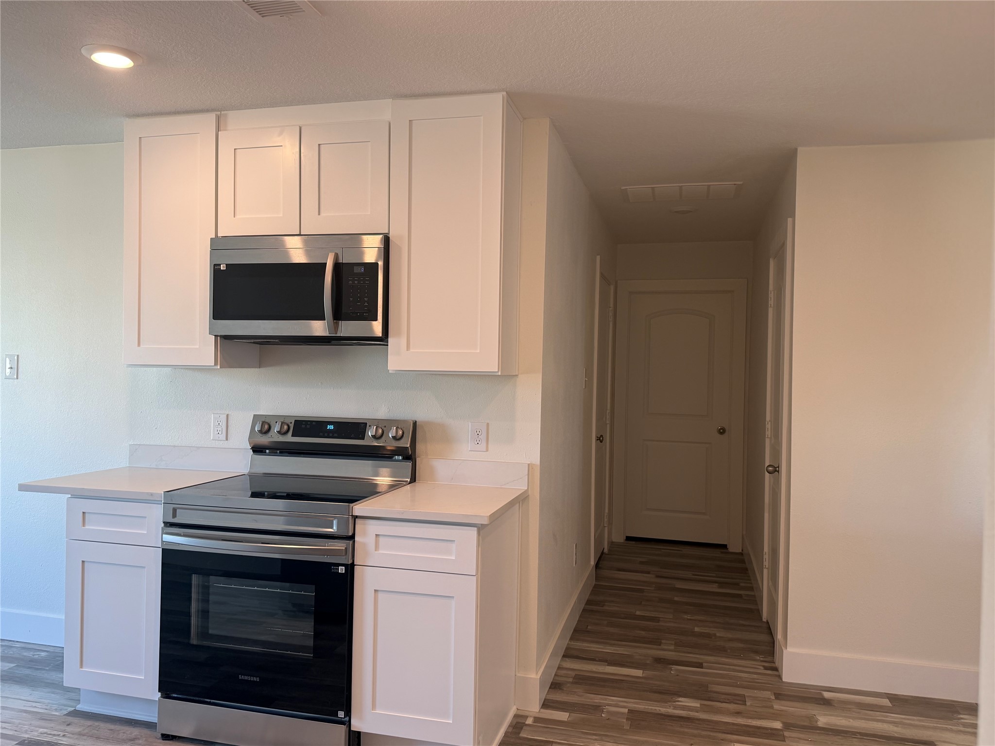 8419 Hannah Rd Cove Cove, TX 77523 - Photo 16 of 21 a kitchen with stainless steel appliances a stove a microwave and cabinets