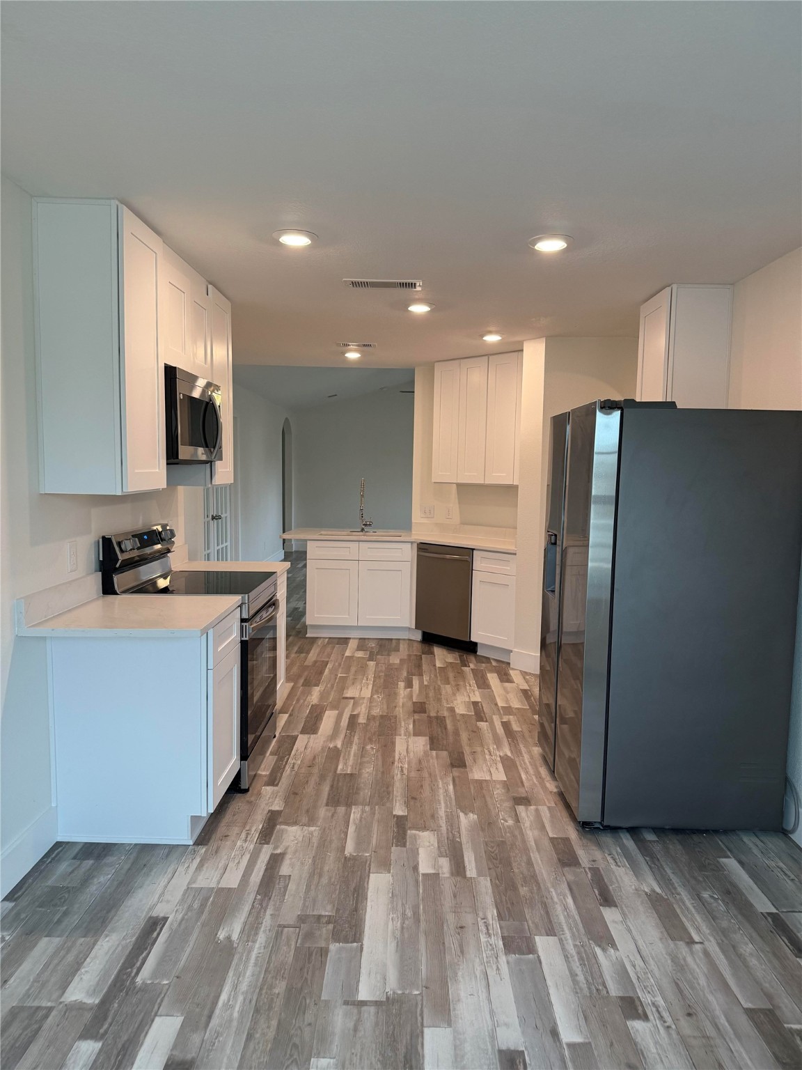 8419 Hannah Rd Cove Cove, TX 77523 - Photo 4 of 21 a large kitchen with a large counter top space stainless steel appliances and cabinets