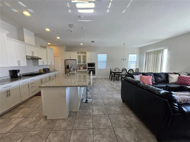 a large kitchen with stainless steel appliances lots of counter top space