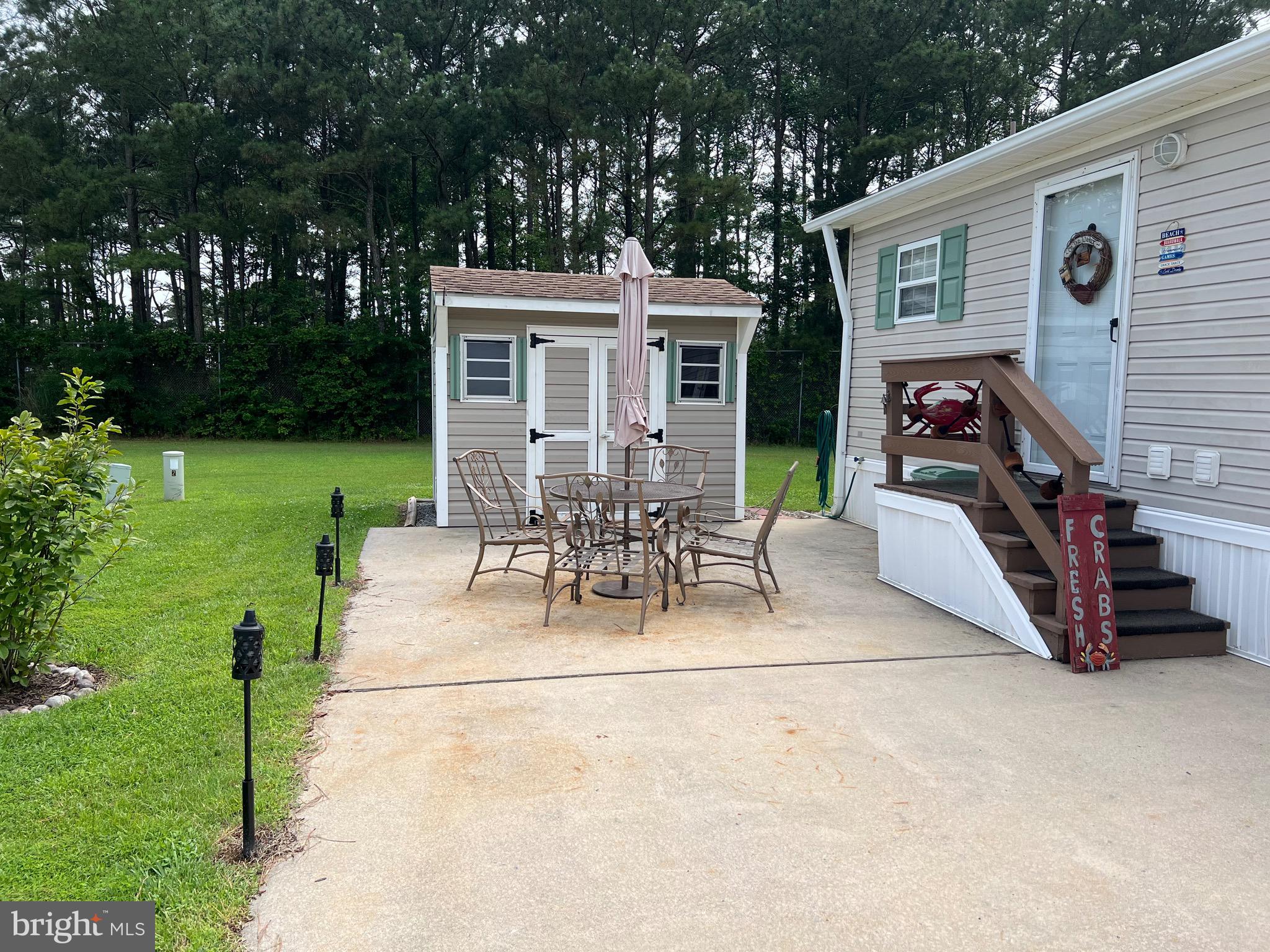 11973 Baywatch Road Berlin, MD 21811 - Photo 4 of 95 Patio with table & Umbrella, 8 x 10 Shed