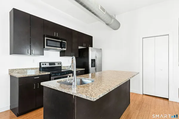 a bedroom with a bed mirror and window