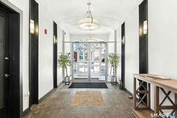 a view of a hallway with wooden floor