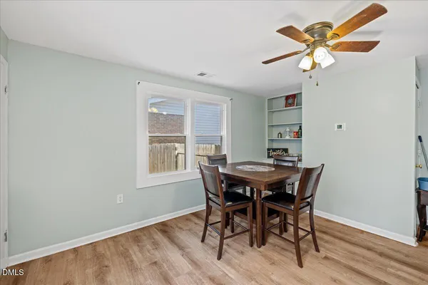 a view of a dining room with furniture and a window