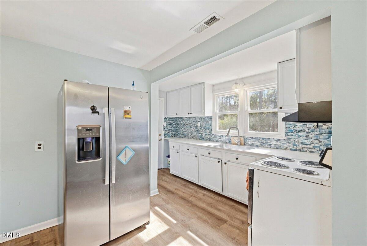 3133 Tryon Road Raleigh, NC 27603 - Photo 16 of 31 a kitchen with stainless steel appliances granite countertop a refrigerator and a stove top oven