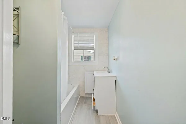 a view of a bathroom with sink and mirror