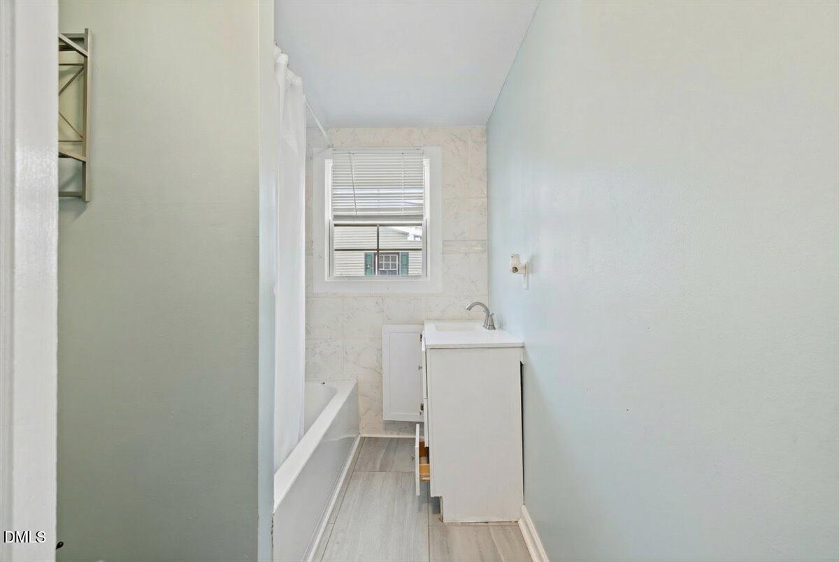 3133 Tryon Road Raleigh, NC 27603 - Photo 17 of 31 a view of a bathroom with sink and mirror