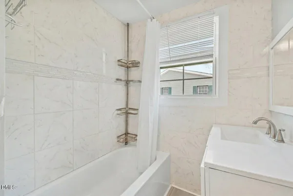 a bath room with a sink and a bath tub