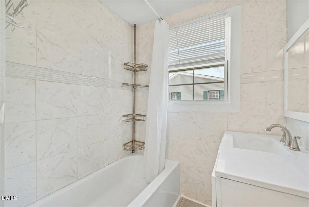 3133 Tryon Road Raleigh, NC 27603 - Photo 18 of 31 a bath room with a sink and a bath tub