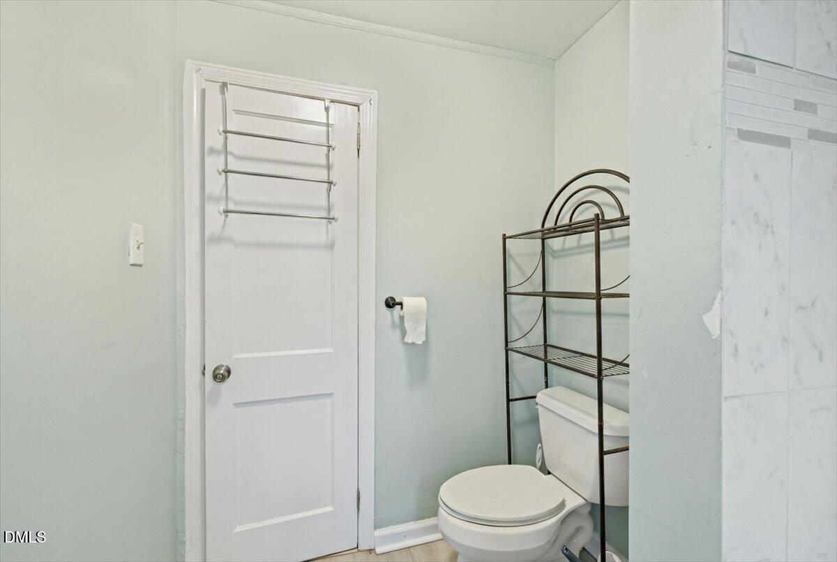 3133 Tryon Road Raleigh, NC 27603 - Photo 19 of 31 a bathroom with a toilet and a shower