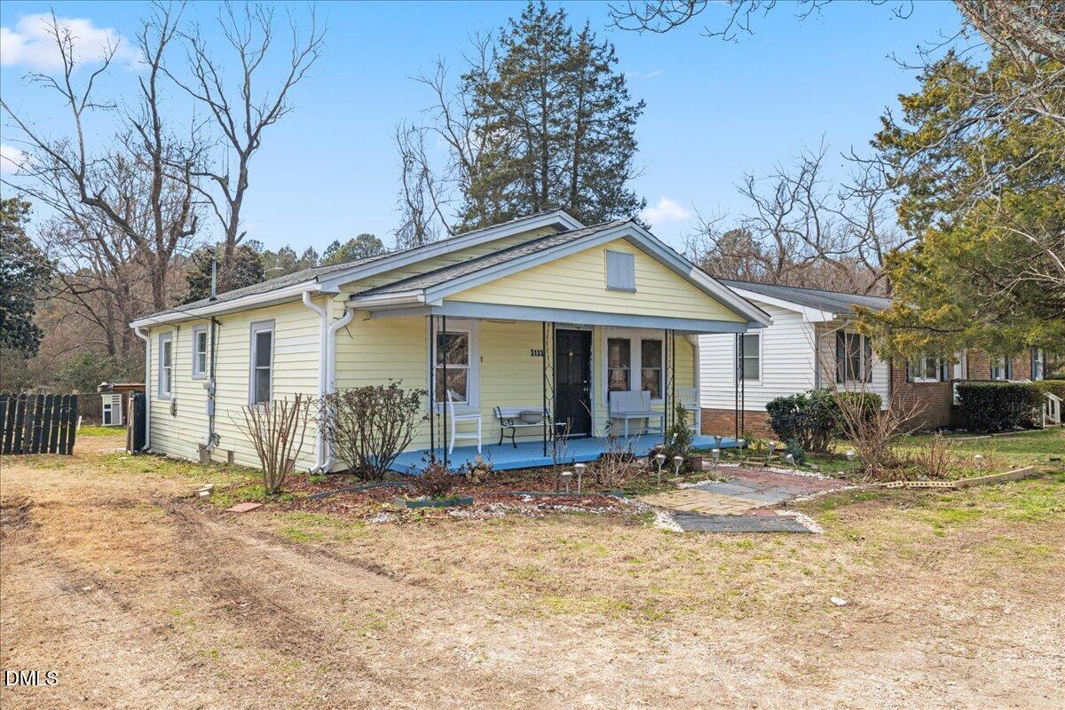 3133 Tryon Road Raleigh, NC 27603 - Photo 2 of 31 a front view of a house with a yard outdoor seating and covered with trees