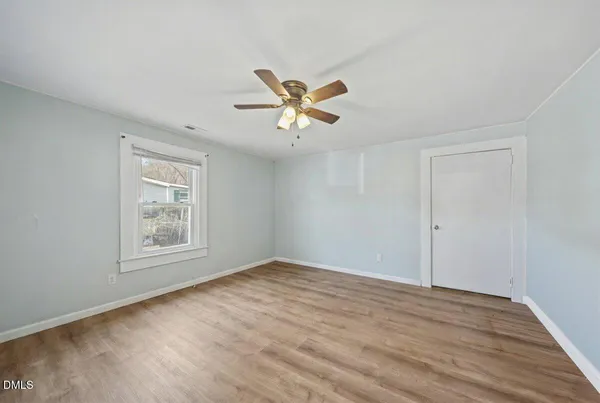 wooden floor in an empty room with a window