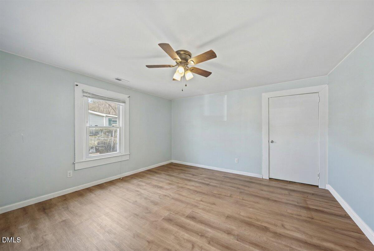 3133 Tryon Road Raleigh, NC 27603 - Photo 21 of 31 wooden floor in an empty room with a window