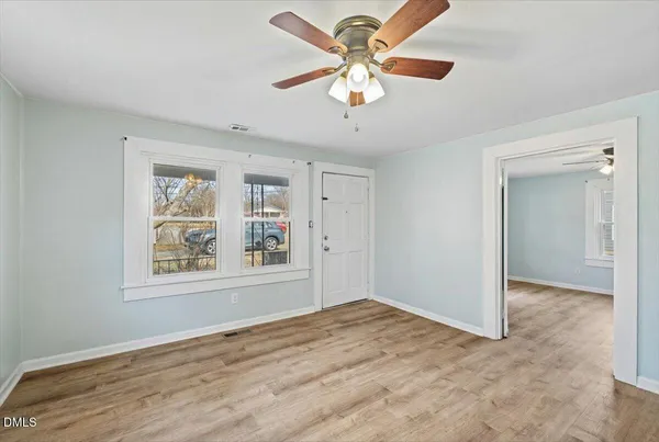 wooden floor in an empty room with a window