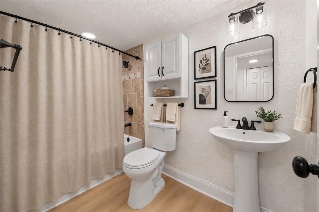 5516 Maple Lane Rowlett, TX 75089 - Photo 15 of 18 a white toilet sitting next to a bathroom sink