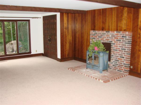 409 Ipswich Road Boxford, MA 01921 - Photo 9 of 20 a view of an empty room with a fireplace and a window