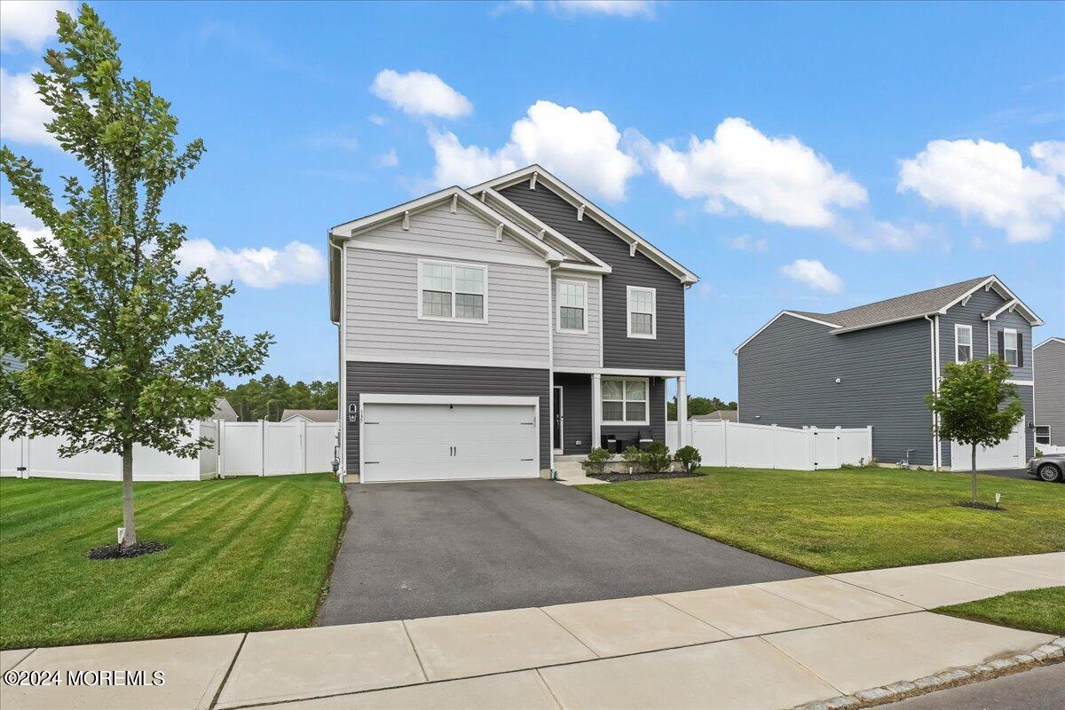 137 Cox Road Barnegat, NJ 08005 - Photo 3 of 40 a front view of a house with a yard and garage