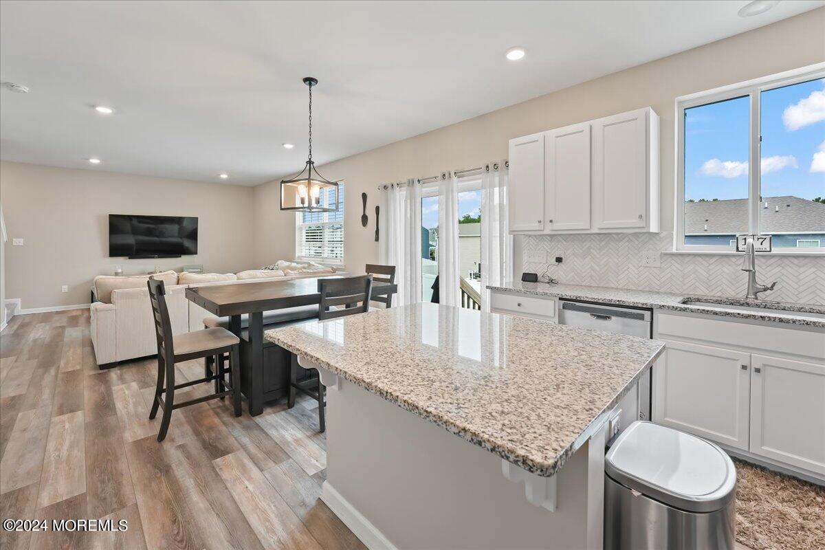 137 Cox Road Barnegat, NJ 08005 - Photo 10 of 40 a kitchen with stainless steel appliances granite countertop a kitchen island hardwood floor sink stove dining table and chairs