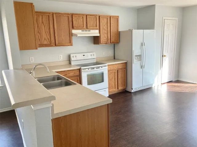 a kitchen with a sink a stove and refrigerator