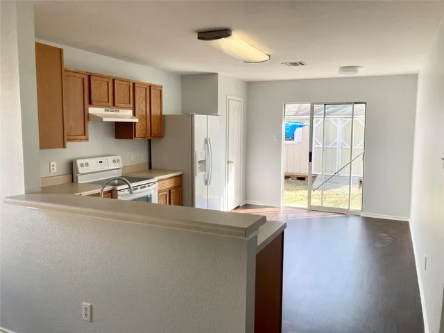 a kitchen with stainless steel appliances a refrigerator and a stove top oven