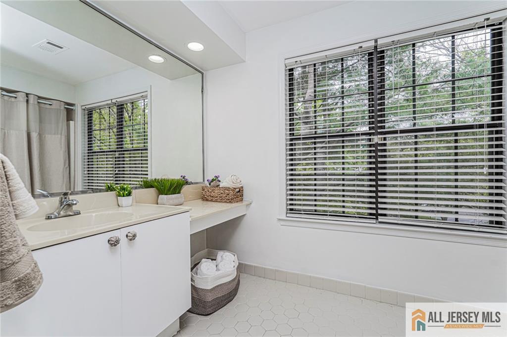 612 Chester Court Helmetta, NJ 08828 - Photo 20 of 31 a bathroom with a sink a toilet and a large mirror
