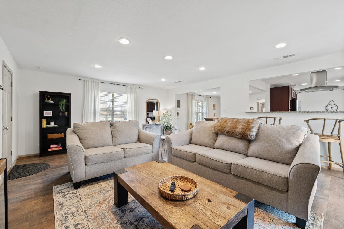 a living room with furniture a rug and a flat screen tv