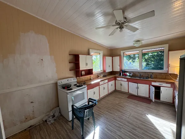 a kitchen with a stove a sink and a refrigerator