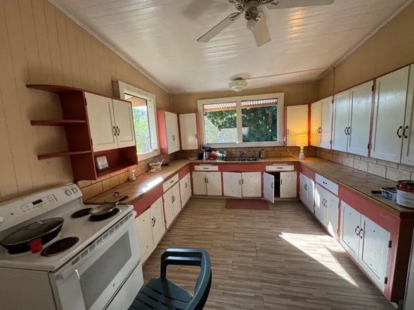 a large kitchen with stainless steel appliances granite countertop a stove and a sink