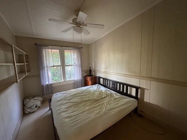 a bedroom with a bed and window