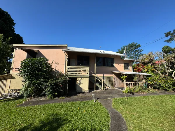 a view of a patio with table and chairs and potted plants with wooden fence