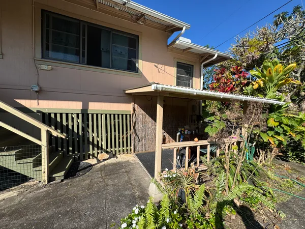 a view of a house with wooden fence