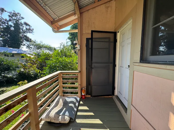 a view of outdoor space with wooden floor and a ceiling fan