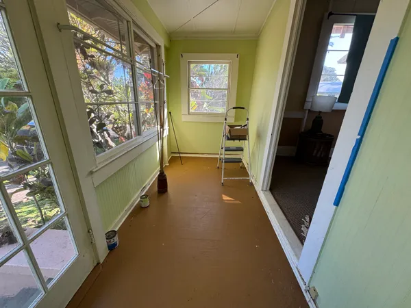 a view of a hallway with furniture and a window