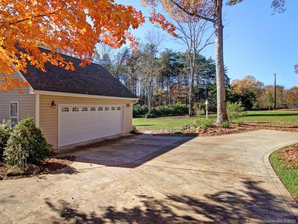 8729 Riverwood Road, Unit 53 Terrell, NC 28682 - Photo 23 of 24 a view of a white house with a yard and large tree