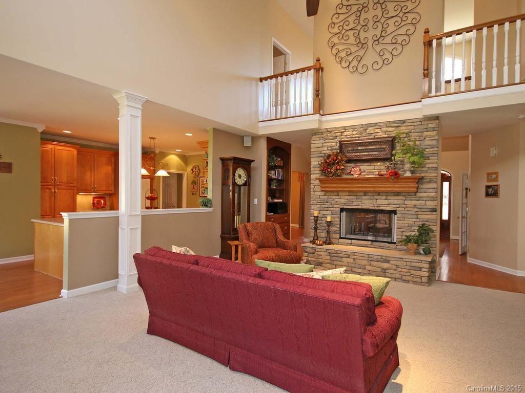8729 Riverwood Road, Unit 53 Terrell, NC 28682 - Photo 6 of 24 a living room with furniture a fireplace and a flat screen tv