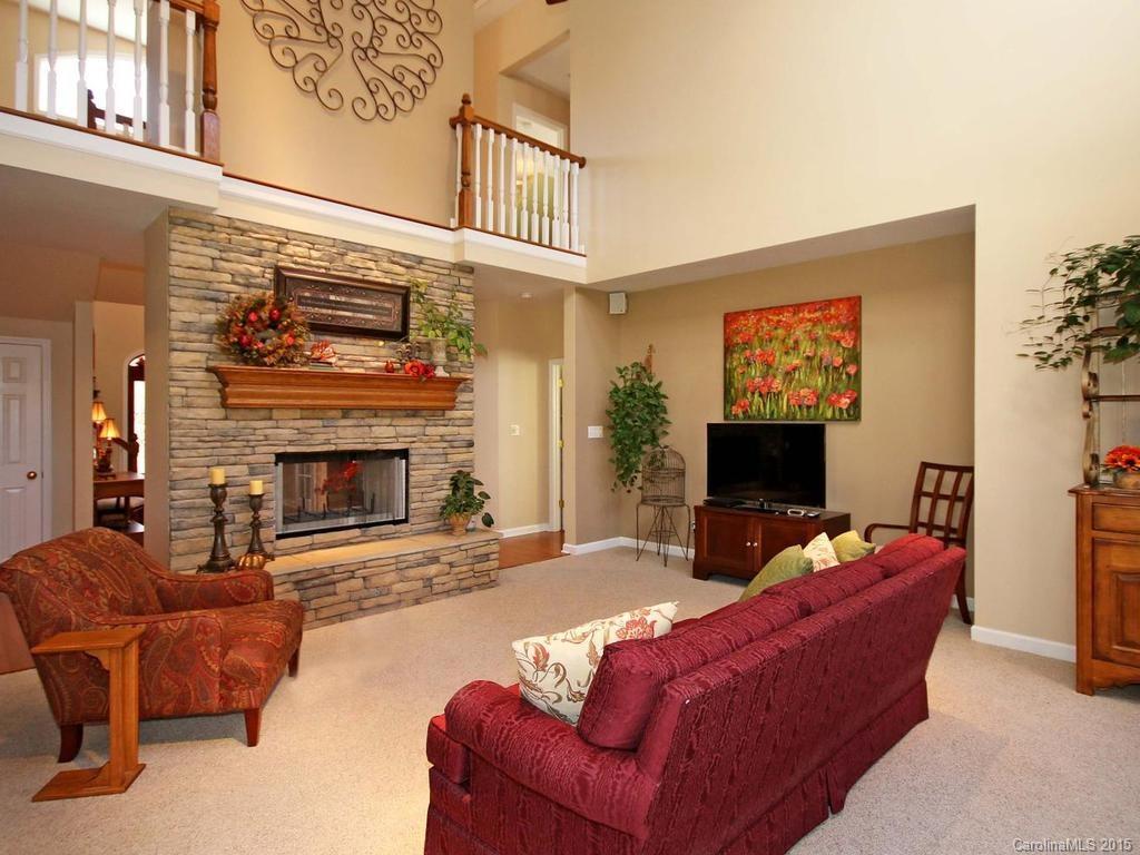 8729 Riverwood Road, Unit 53 Terrell, NC 28682 - Photo 8 of 24 a living room with furniture a flat screen tv and a fireplace