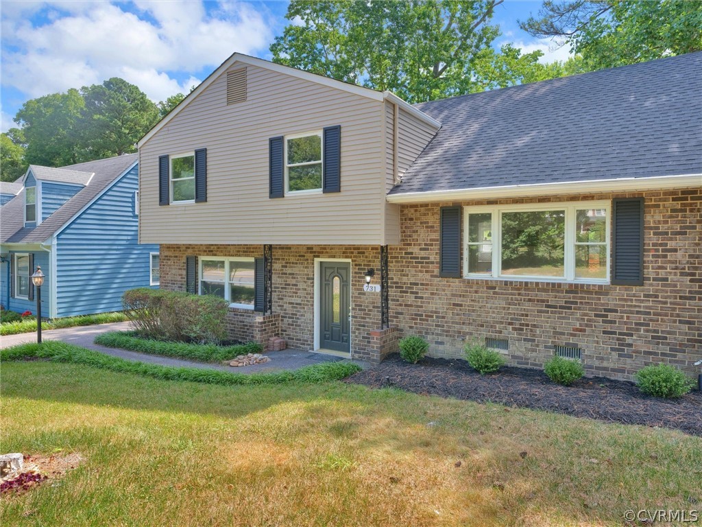 a front view of a house with a garden and yard