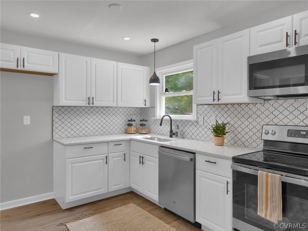 731 Adkins Road Chesterfield, VA 23236 - Photo 18 of 37 a kitchen with a sink stove and microwave