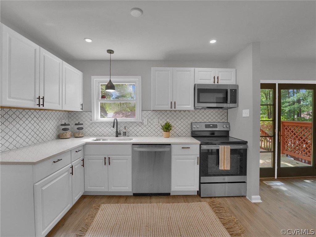 731 Adkins Road Chesterfield, VA 23236 - Photo 19 of 37 a kitchen with stainless steel appliances granite countertop a stove a sink and a refrigerator