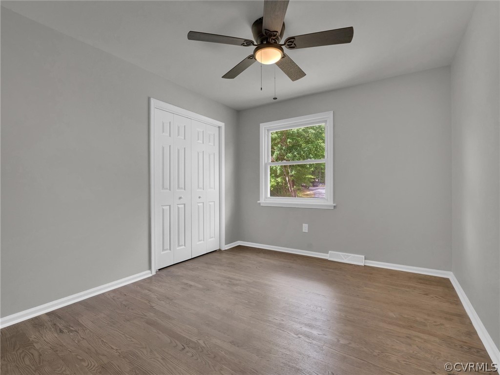 731 Adkins Road Chesterfield, VA 23236 - Photo 22 of 37 an empty room with wooden floor ceiling fan and windows